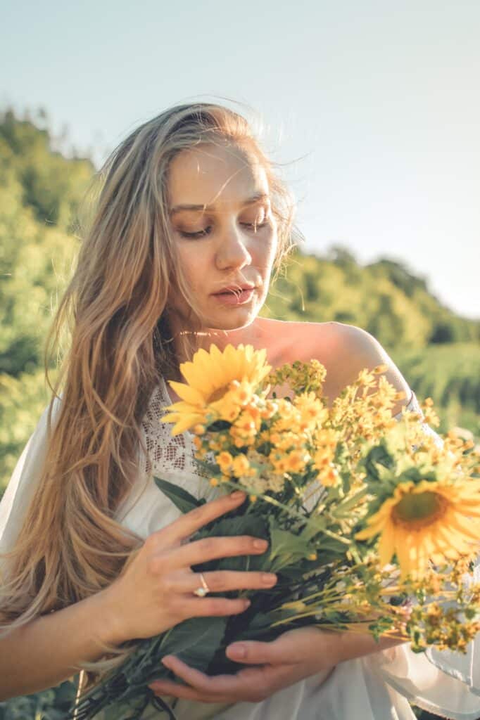 How to Harvest and Dry Herbs. Traditional medicinal plants. Woman picking flower in summer field