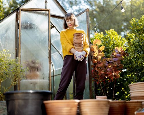 Woman with jugs in garden